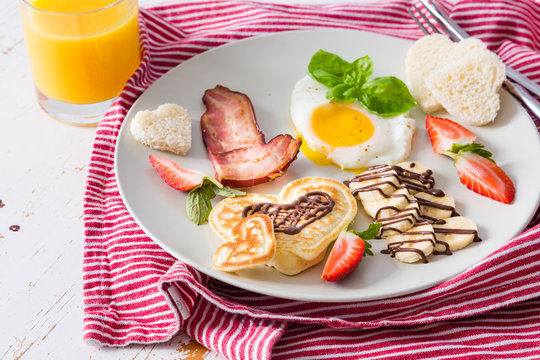 Valentine's day breakfast - bacon, egg, pancake, banana
