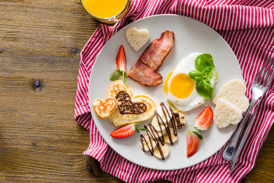 Valentine's day breakfast - bacon, egg, pancake, banana
