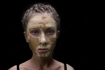 Obraz premium woman with facial mask,isolated on black