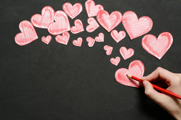 Greeting card with a red drawing hearts and space for text on dark background