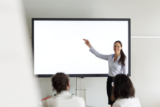 Smiling businesswoman leading a presentation