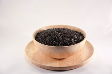 Fototapeta na wymiar The Organic rice in wooden bowl. The purple rice organic in wooden bowl.