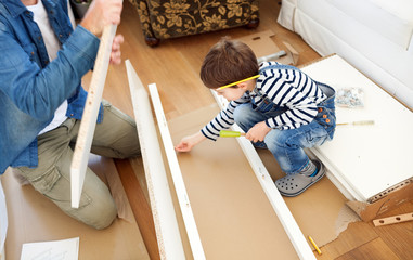 Father and son assembling furniture - obrazy, fototapety, plakaty