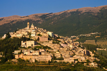 City on a hill in Italy at sunset.