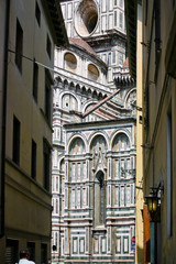 The facade of the cathedral of Santa Maria del Fiore view of the adjacent lane. Florence, Italy.