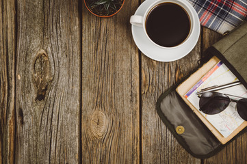 Accessories for travel top view on wooden background with copy space. Adventure and wanderlust concept image with travel accessories. Preparing for an exotic trip, journey and sightseeing.