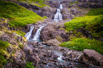 Fototapeta premium Iceland, green landscape and waterfalls