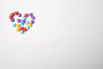 Miniature plastic hearts love on white background