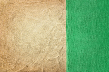 Fototapeta premium Top view of sandy beach with towel frame. Background with copy space and visible sand texture.