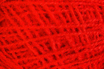 Red woolen yarn ball - macro image.