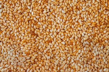 Sesame seeds in honey - macro background image.