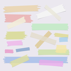 Multiple pieces of colorful sticky tape in different shapes on grey background - 134027769