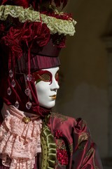 Fototapeta na wymiar Beautiful costume and venetian mask during Venice Carnival symbol of tradition, refinement and creativity