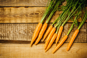 fresh and crunchy carrots on a wooden table