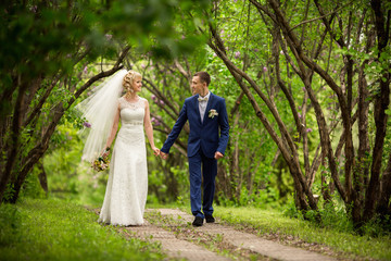 Wedding couple walking in park