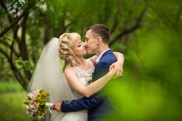Wedding couple, bride and groom kissing outdoor