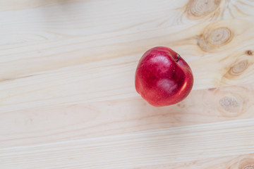 Fresh red apple on wooden decks.