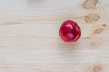 Fresh red apple on wooden decks.
