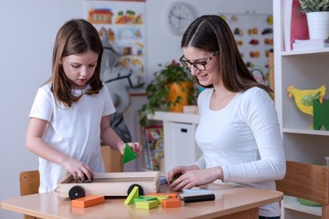 Preschool Teacher Playing With Cute Girl