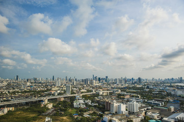 Aerial view of Bangkok city under blue sky and white cloud.