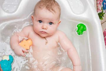 Baby bathing in the bath