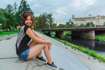 Asian girl listening to music with headphones