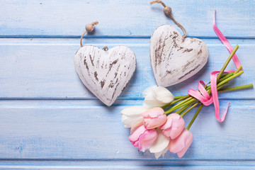 Two decorative hearts and tender white and pink spring tulips  o