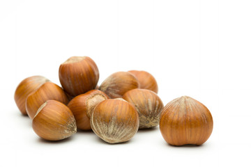 Pile of hazelnuts on a white background