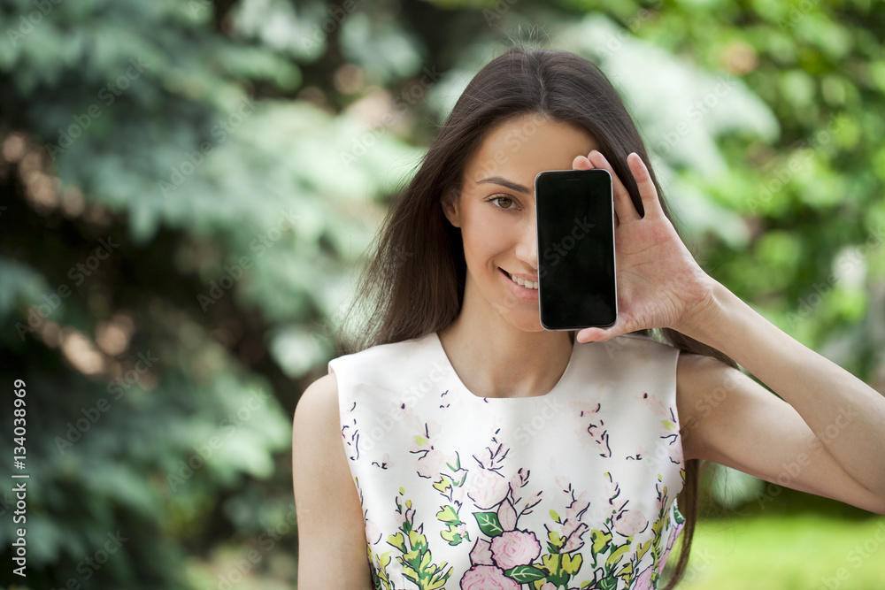 Canvas Prints Young beautiful girl showing your smartphone screen