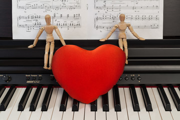 Red heart on a black piano