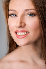 Fototapeta premium portrait of attractive Caucasian smiling woman isolated on white, studio shot, vertical image
