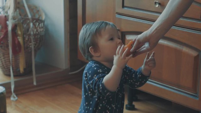 Little baby asking persimmon, then try to eat it