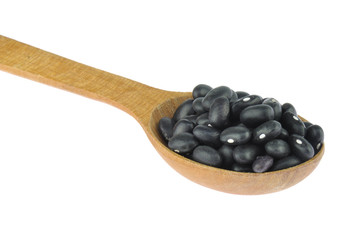 Black beans in wooden spoon