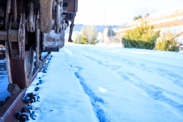 Train closeup on snowy railroad tracks