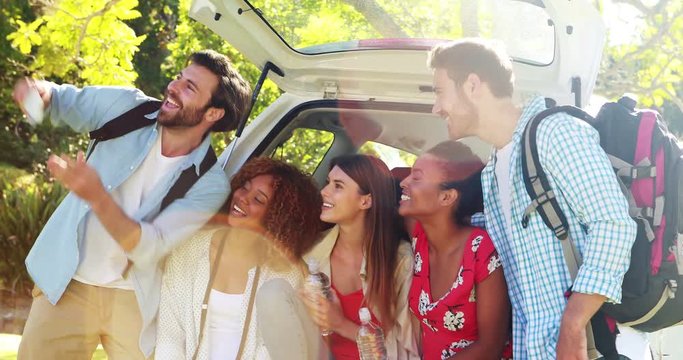 Group of friends taking a selfie from trunk of car