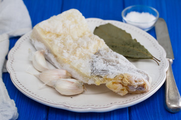 frozen cod fish with garlic on white plate