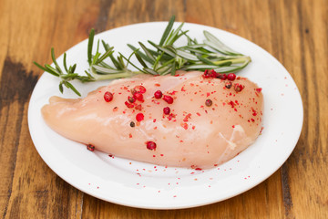 raw chicken with pink pepper and rosemary
