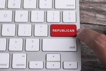 Close up of finger on keyboard button with REPUBLICAN word.