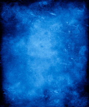 Blue grunge vintage textured background with faded central area for your text or picture.