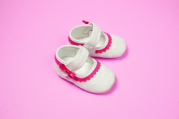 Children's shoes pink background.