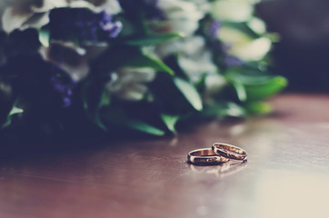 Wedding rings on wooden surface