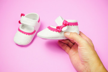 Children's shoes pink background.