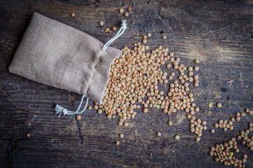 Brown dried lentils in a burlap bag