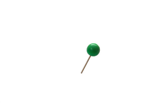 stationery small pin with a ball stuck in a white isolated background