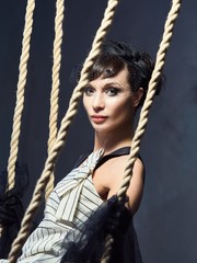 Young girl in the Studio on a swing.