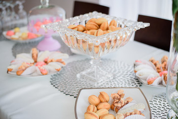 Pastry in form of nuts served in beautiful crystal vase stands o