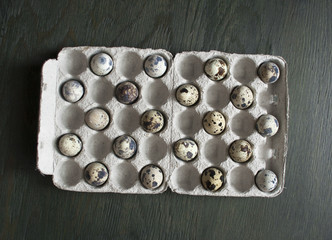 Quail eggs in a cardboard box. Chess order. Eco-product in envir