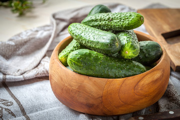 Fresh cucumbers in a wooden bowl.