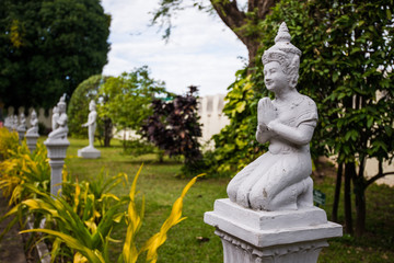 Old statue of buddha prayer at thai asian temple