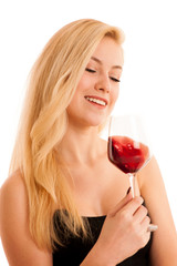 Cute blonde woman drinks a glass of red wine isolated over white